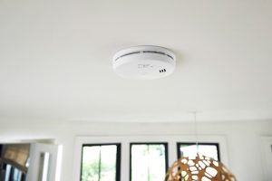 Smoke alarm installed on a residential ceiling for early fire detection.