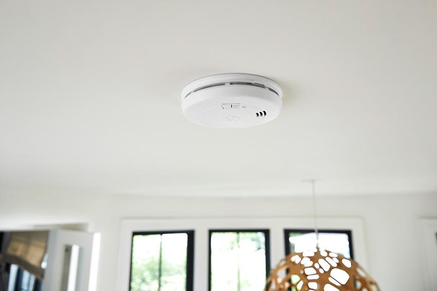 Smoke alarm installed on a residential ceiling for early fire detection.